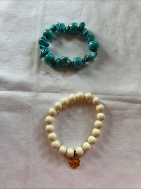 Turquoise bracelet and ivory bracelet.